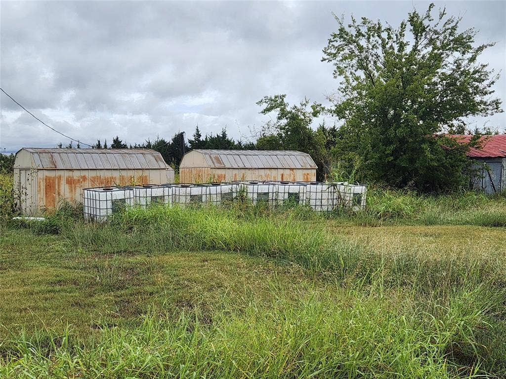 1513 S Fm 1138, Royse City, TX 75189 Storage sheds and water tanks on property.