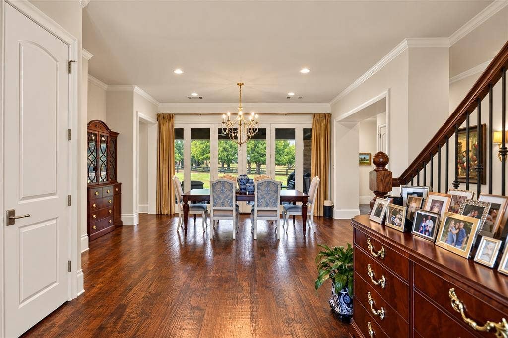 Hardwood flooring throughout, recessed lighting, crown molding, double French doors, and a chandelier