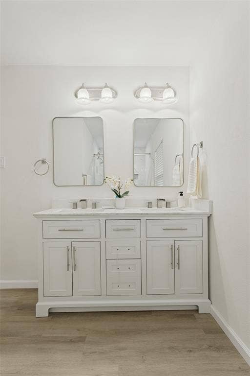 Dual vanity with white cabinetry, rectangular undermount sinks, and a light-toned countertop