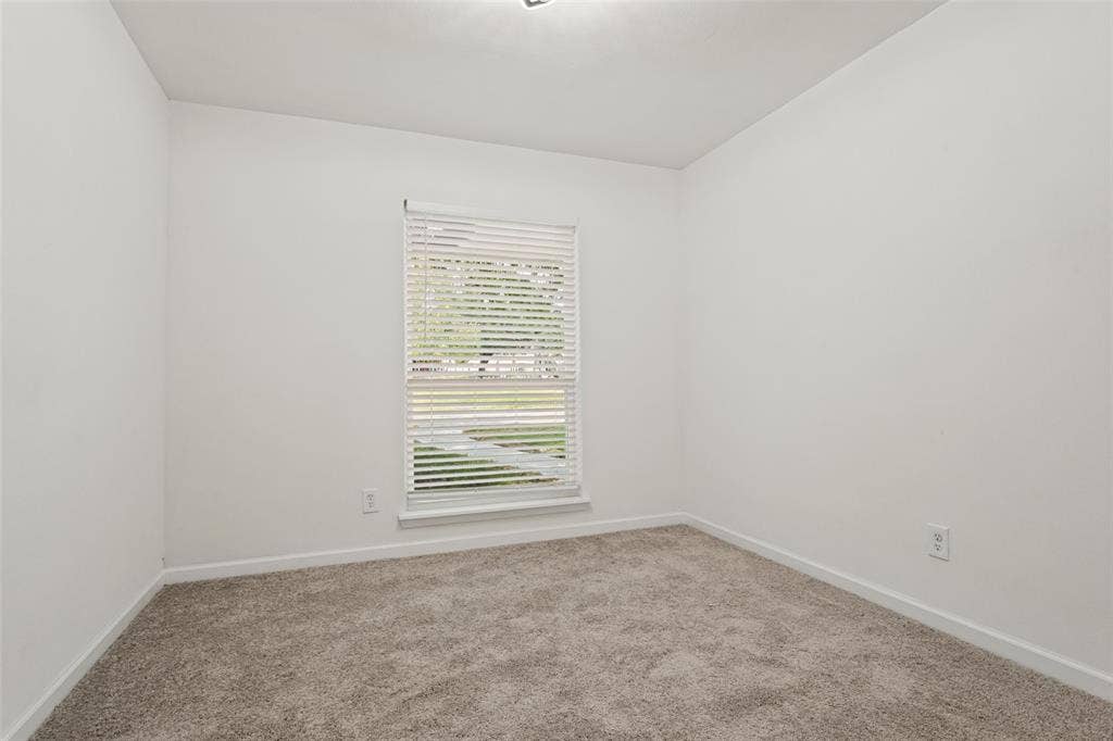 Carpeted flooring, white walls, window with blinds, and recessed ceiling light