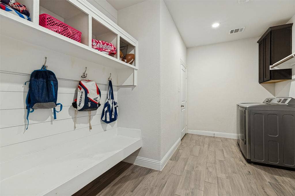 Built-in organizational shelving, integrated bench seating, and wood-finish flooring