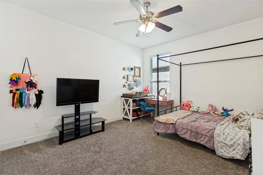 Textured carpeting, white walls, and a ceiling fan with integrated lighting