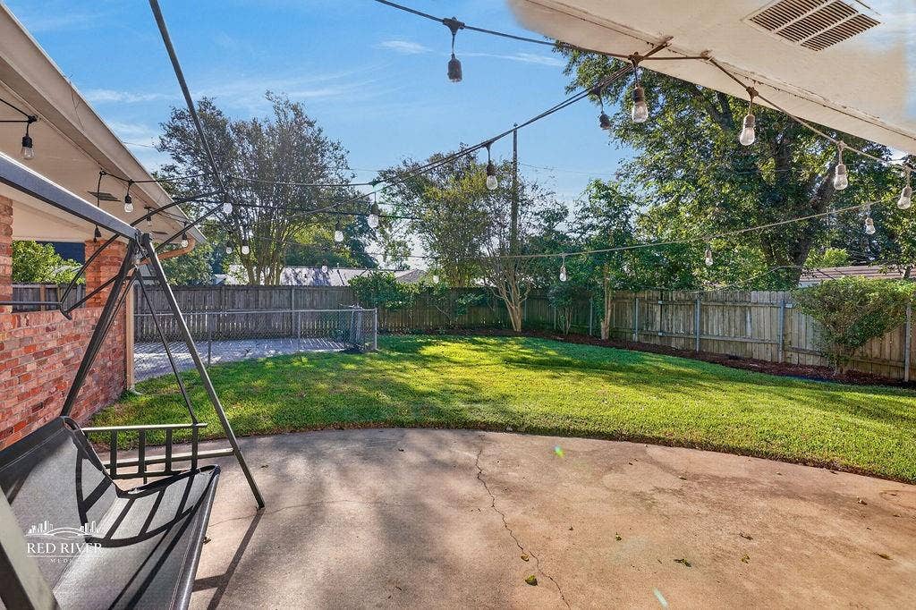 Rear patio overlooking fenced back yard