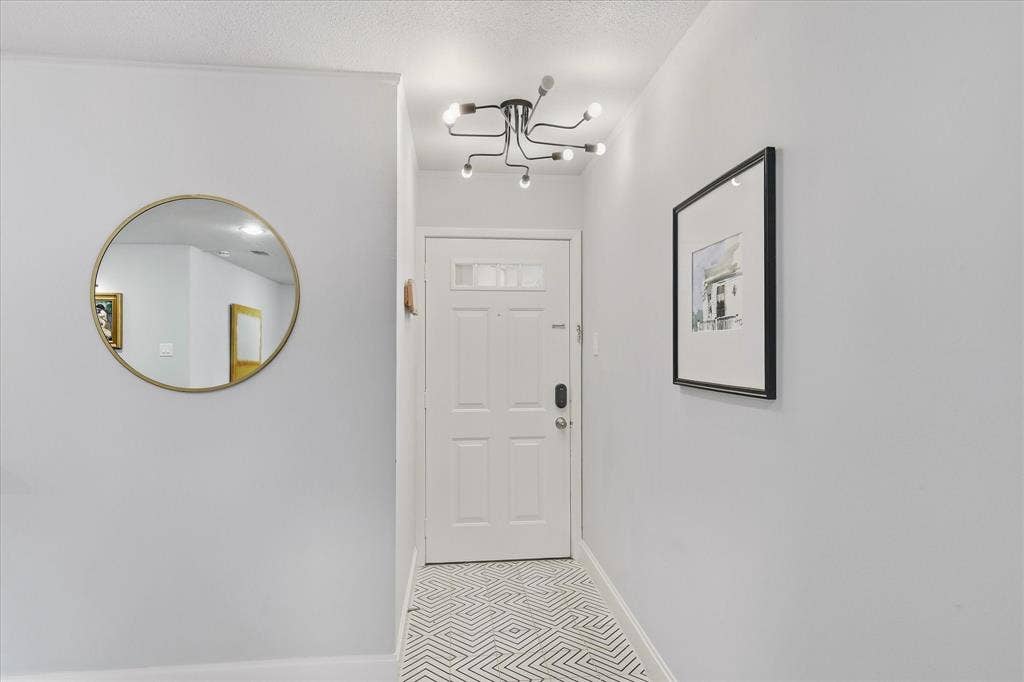 306 W Northgate Drive, Irving, TX 75062 White paneled entry door, patterned tile flooring, and a contemporary ceiling-mounted light fixture