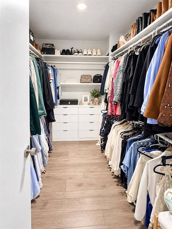 306 W Northgate Drive, Irving, TX 75062 Walk-in closet, hanging rods, recessed lighting, and faux wood-finish flooring