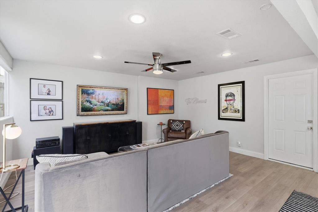 306 W Northgate Drive, Irving, TX 75062 Recessed ceiling lighting, faux wood-finish flooring, ceiling fan, white paneled door, and a multi-pane window