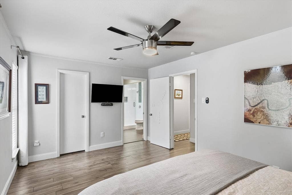 306 W Northgate Drive, Irving, TX 75062 Faux wood-finish flooring with a ceiling fan featuring a light fixture