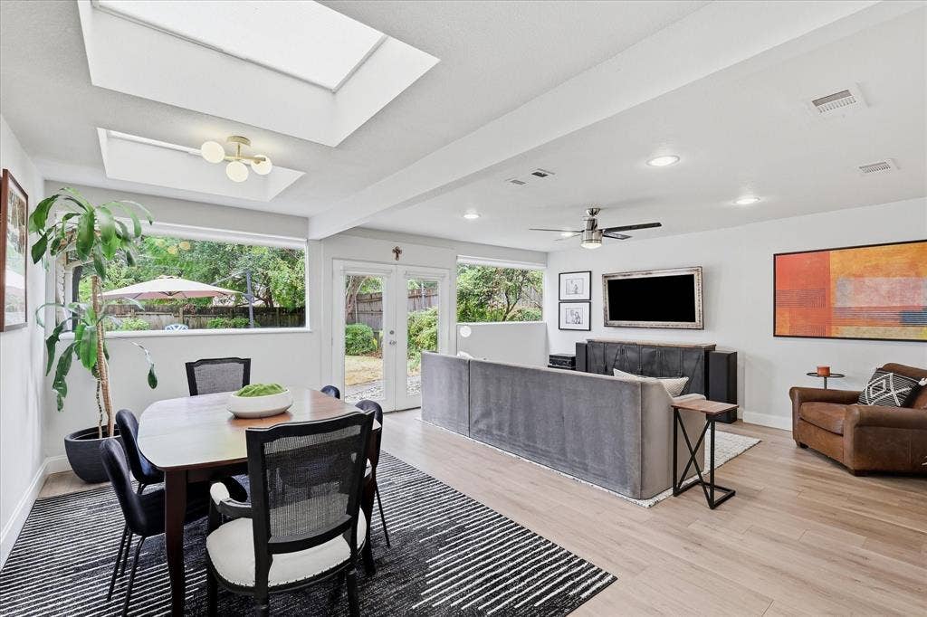 306 W Northgate Drive, Irving, TX 75062 Recessed lighting, skylights, wood-finish flooring, a ceiling fan, and French doors