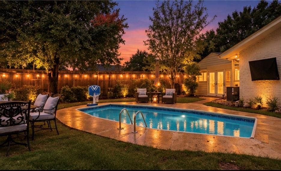 306 W Northgate Drive, Irving, TX 75062 Private backyard oasis featuring an in-ground swimming pool, extensive paving, mature landscaping, and a privacy fence
