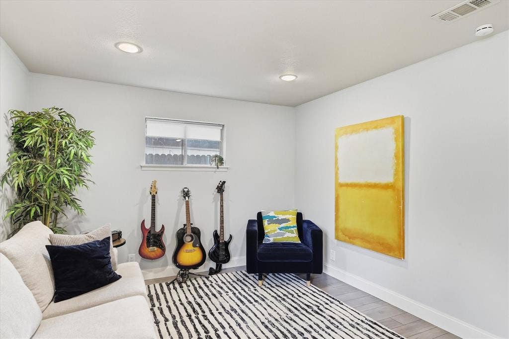 306 W Northgate Drive, Irving, TX 75062 Recessed lighting illuminates neutral walls and faux wood-finish flooring