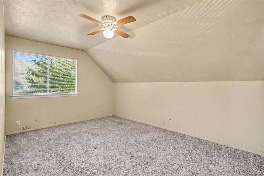 1414 Finley Road, Irving, TX 75062 Carpeted flooring, sloped ceiling, window with blinds, ceiling fan with light fixture