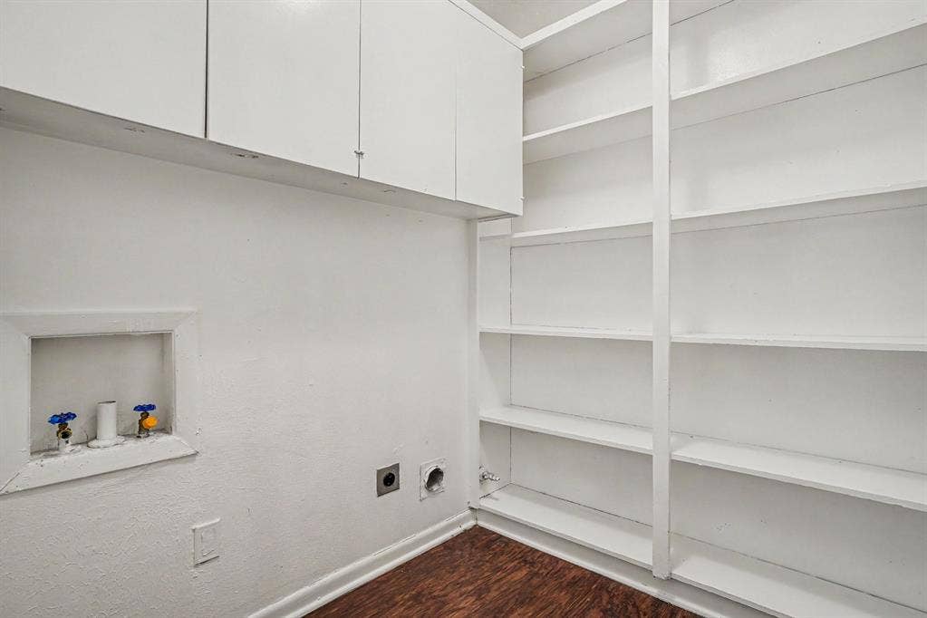 1414 Finley Road, Irving, TX 75062 White built-in cabinetry, extensive built-in shelving, wood-finish flooring, and laundry hookups