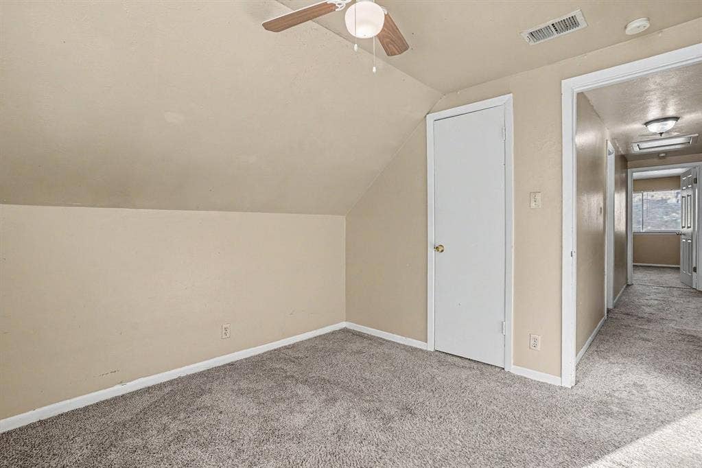 1414 Finley Road, Irving, TX 75062 Sloped ceiling design, recessed lighting, ceiling fan with light fixture, wall-to-wall carpeting, interior door with brass-finish hardware