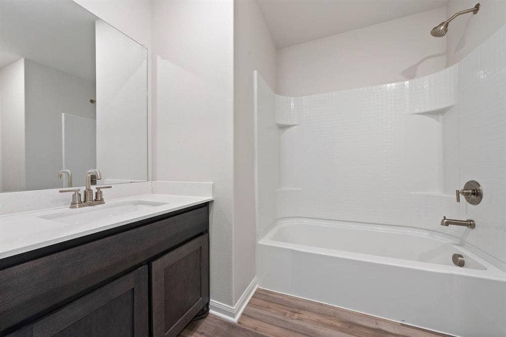 6308 Hyena Hollow Drive, Dallas, TX 75241 Bathroom featuring vanity, wood-type flooring, and bathtub / shower combination