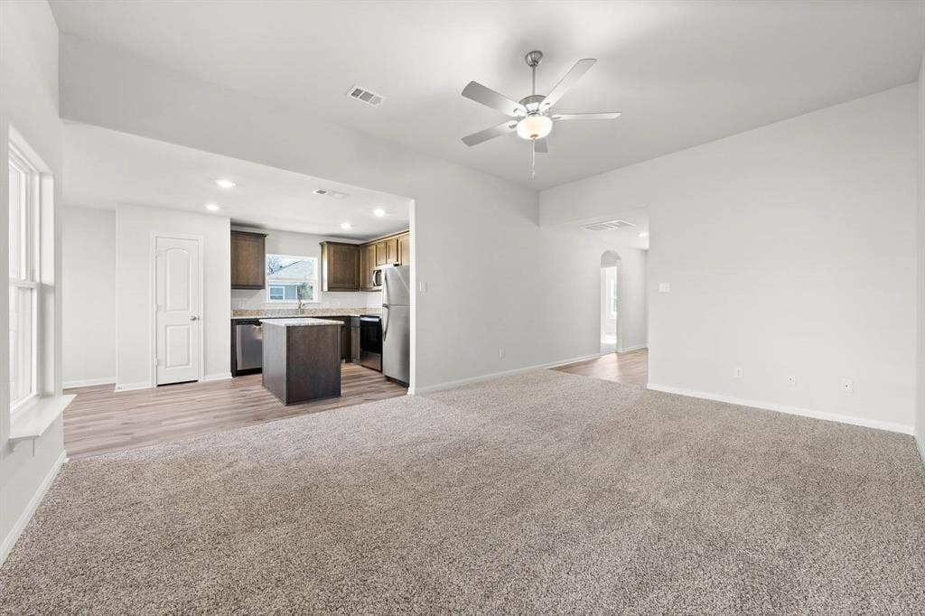 6308 Hyena Hollow Drive, Dallas, TX 75241 Unfurnished living room featuring carpet flooring, ceiling fan, and sink