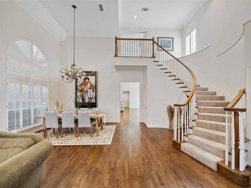 8640 Breakers Point, Dallas, TX 75243 Two-story foyer with a curved staircase, hardwood flooring, and high ceilings