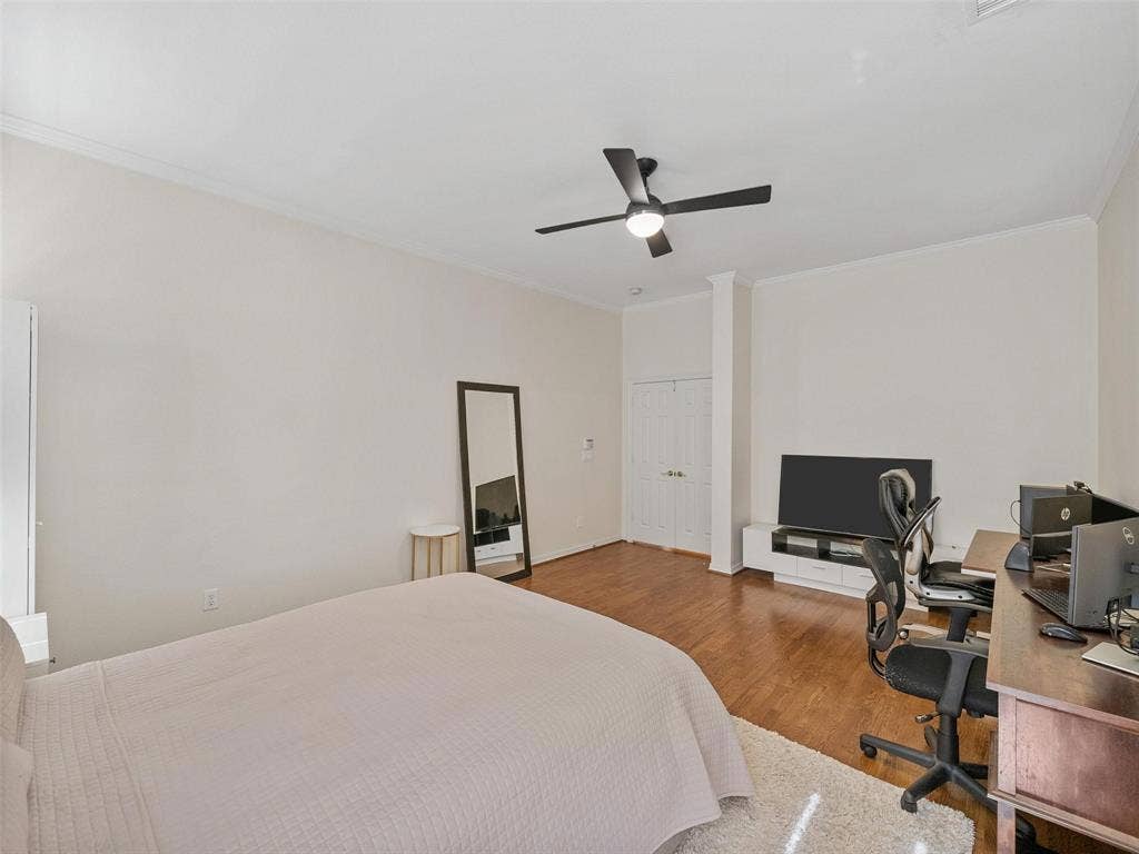 8640 Breakers Point, Dallas, TX 75243 Hardwood-finish flooring, crown molding, double bi-fold doors, and a ceiling fan