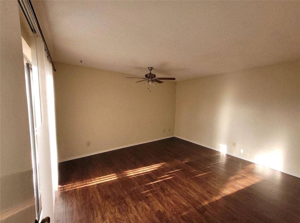 1801 W Spring Creek Parkway, #F2, Plano, TX 75023 Spacious room featuring wood-finish flooring, light-toned walls, and a ceiling fan