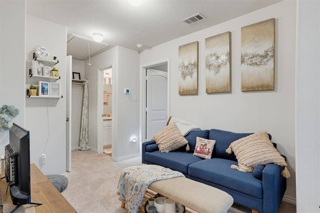 5525 Willamette Drive, Fort Worth, TX 76119 Neutral wall color, carpeted flooring, built-in shelving, white paneled doors, and ceiling lighting