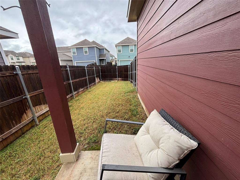 5525 Willamette Drive, Fort Worth, TX 76119 Expansive backyard featuring a manicured lawn, full wood fencing, and a concrete patio