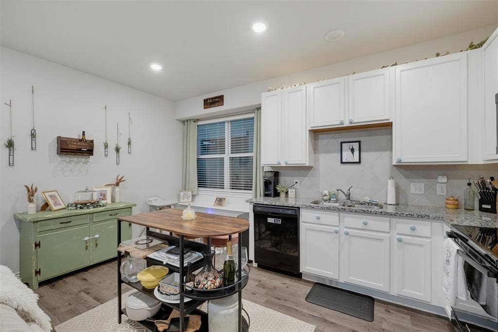 5525 Willamette Drive, Fort Worth, TX 76119 White shaker-style cabinetry, granite countertops, and stainless steel sink