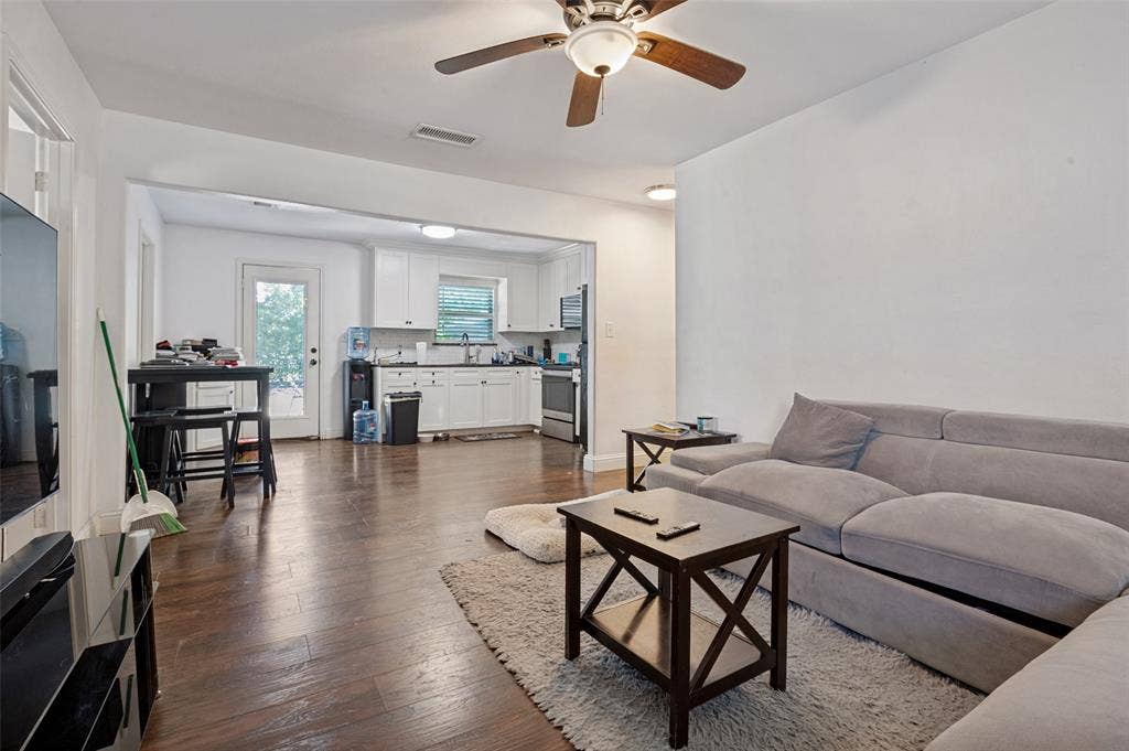 Open-concept living area featuring wood-finish flooring, a ceiling fan, and recessed lighting