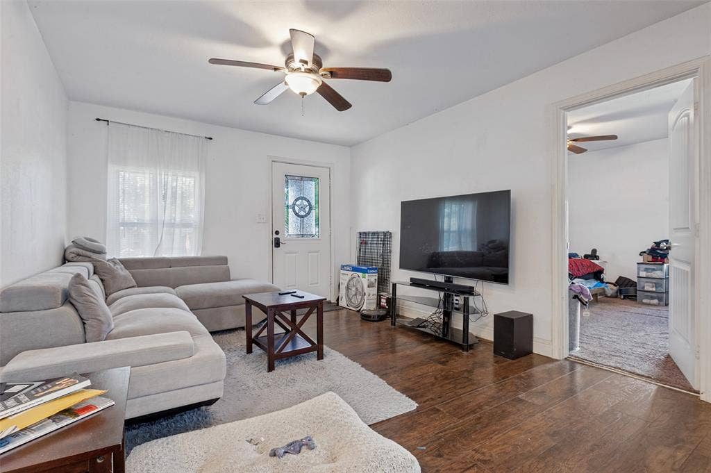 Hardwood-style flooring throughout, with a ceiling fan overhead