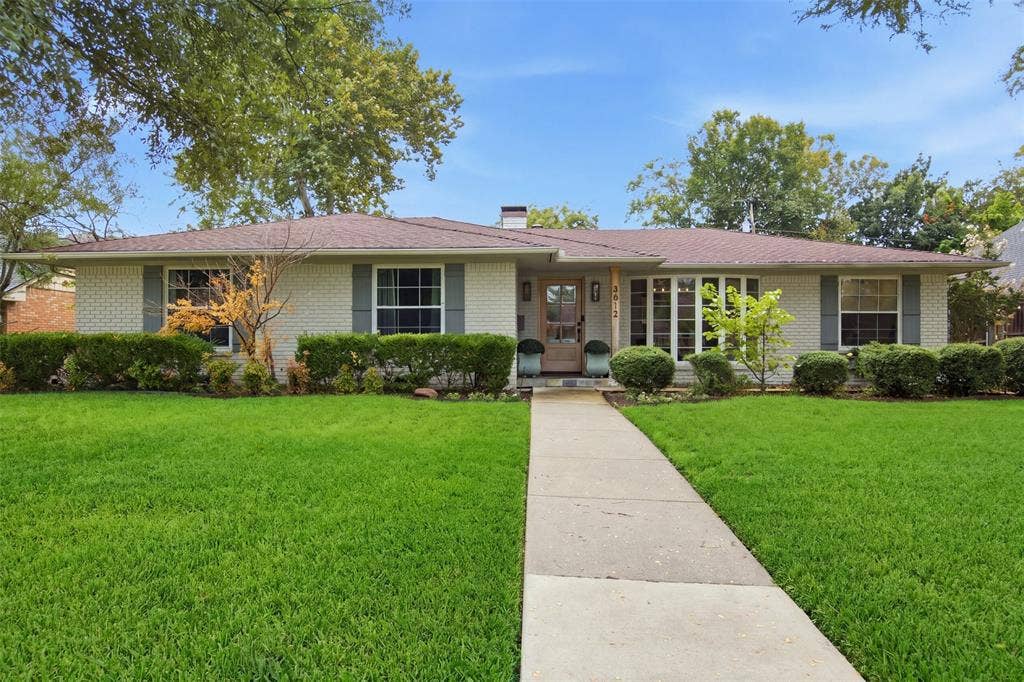 3612 Regent Drive, Dallas, TX 75229 Brick exterior with painted finish, shuttered windows, a gabled roofline, front walkway, and mature landscaping