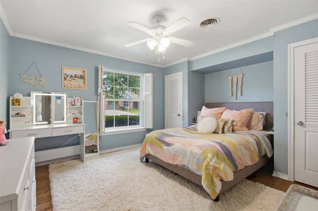 3612 Regent Drive, Dallas, TX 75229 Hardwood-style flooring with crown molding, window with plantation shutters, ceiling fan, and built-in alcove