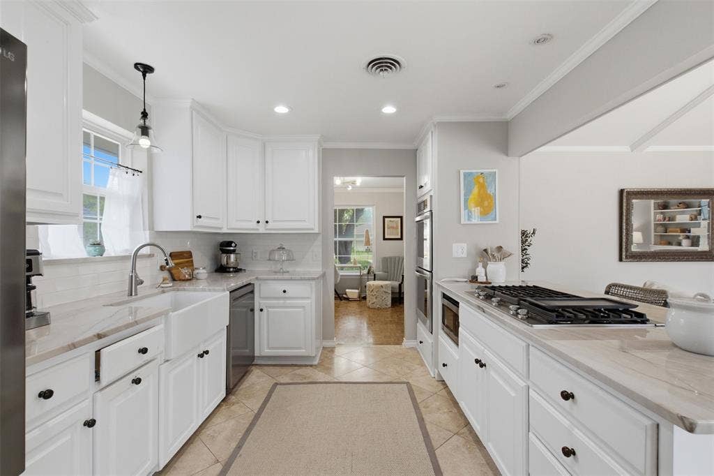 3612 Regent Drive, Dallas, TX 75229 White cabinetry, recessed lighting, tile flooring, built-in double ovens, and a gas cooktop