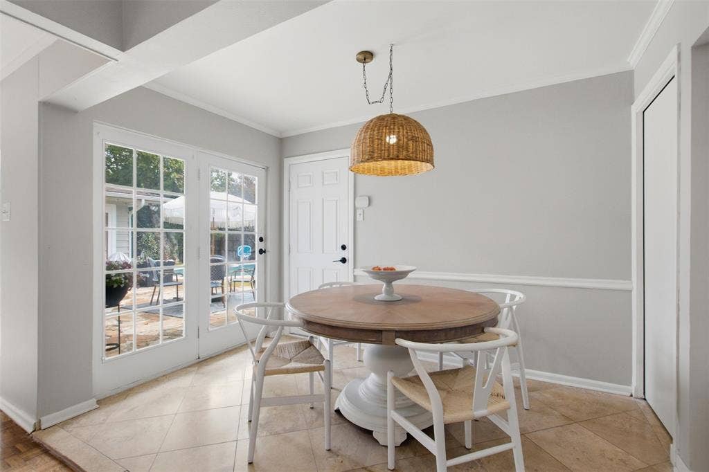 3612 Regent Drive, Dallas, TX 75229 French doors with multiple lites, neutral tile flooring, light gray walls with crown molding and chair rail, and a woven pendant light fixture