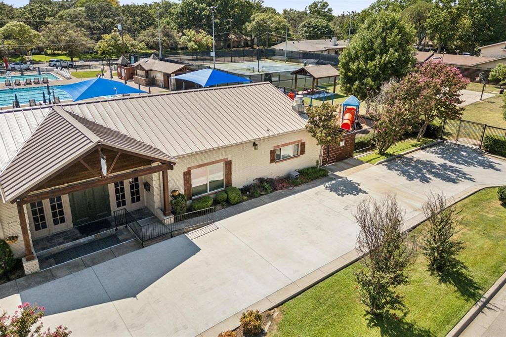 3612 Regent Drive, Dallas, TX 75229 Building exterior with a metal roof, prominent covered entry, and brick facade