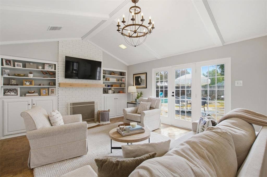 3612 Regent Drive, Dallas, TX 75229 Vaulted ceiling with exposed beams and a decorative chandelier