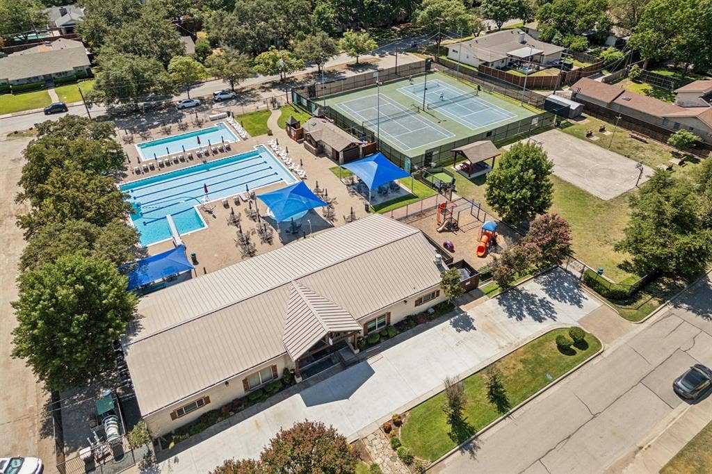 3612 Regent Drive, Dallas, TX 75229 Expansive community building with multiple swimming pools, tennis courts, and a dedicated play area