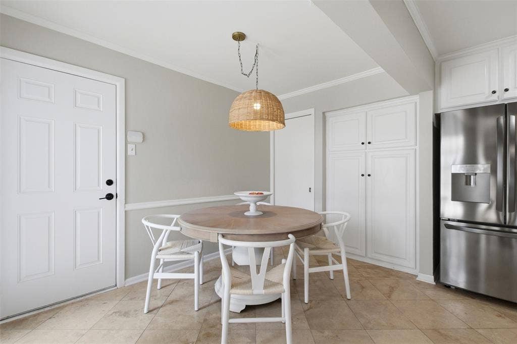 3612 Regent Drive, Dallas, TX 75229 Built-in white cabinetry, stainless steel refrigerator, and recessed lighting