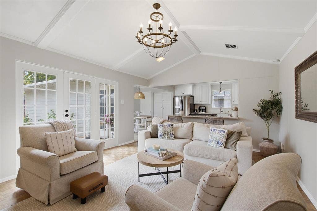 3612 Regent Drive, Dallas, TX 75229 Vaulted ceiling with exposed beams, decorative chandelier, wood-finish flooring, white French doors, and a kitchen pass-through