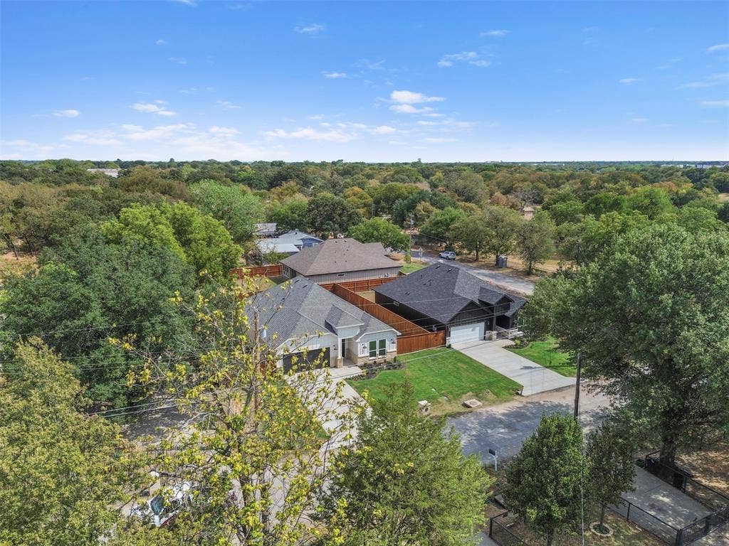 Aerial perspective showcasing residential properties with a rich tree canopy