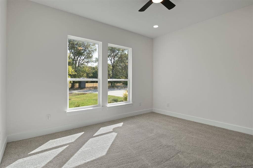 2507 Picadilly Boulevard, Mesquite, TX 75149 Light gray carpeting, white walls, two windows, recessed lighting, and a ceiling fan