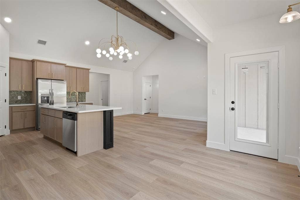 2507 Picadilly Boulevard, Mesquite, TX 75149 Vaulted ceiling with exposed wood beam and chandelier