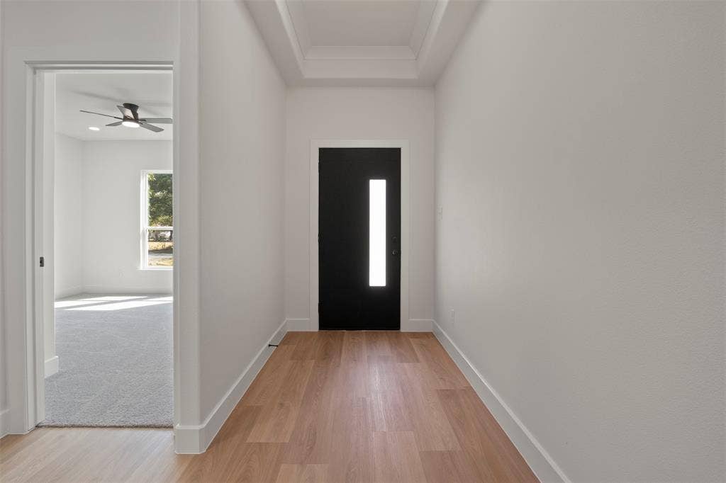 2507 Picadilly Boulevard, Mesquite, TX 75149 Wood-finish flooring leading to a black entry door with a vertical frosted glass insert, and a tray ceiling detail
