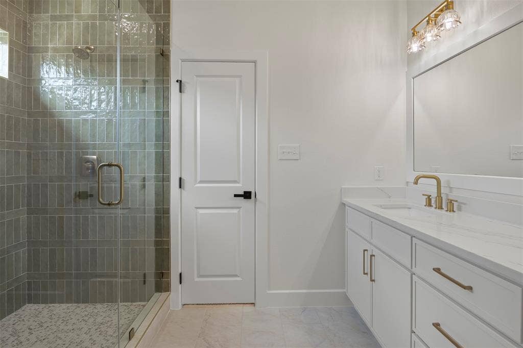 2507 Picadilly Boulevard, Mesquite, TX 75149 Frameless glass shower enclosure with gray vertical tile