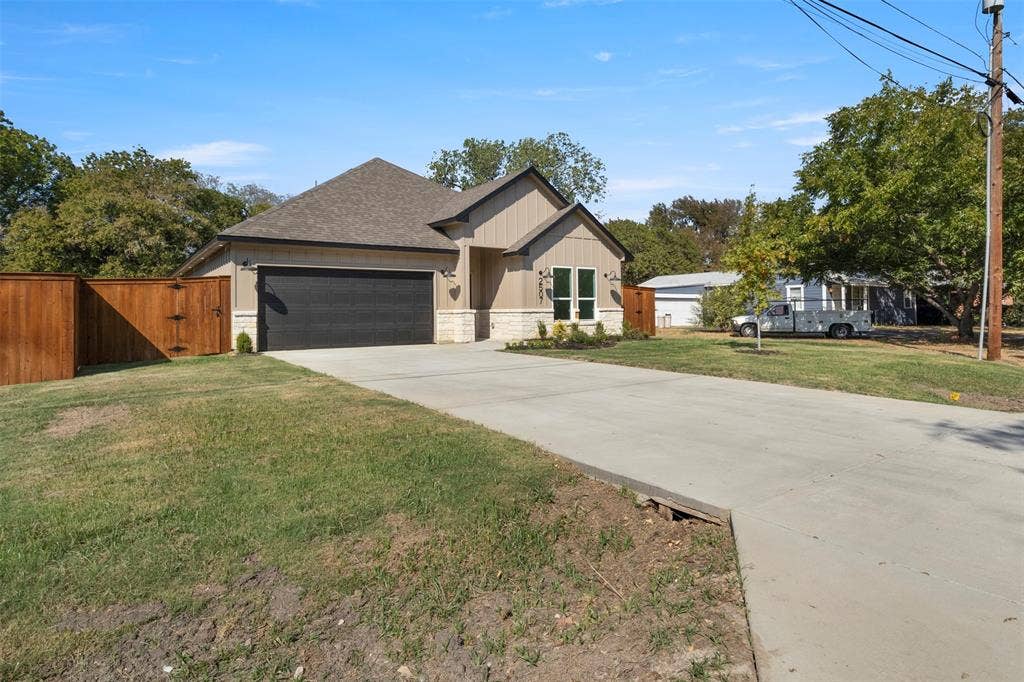 2507 Picadilly Boulevard, Mesquite, TX 75149 Single-story residence featuring a two-car garage, wood privacy fence, and concrete driveway