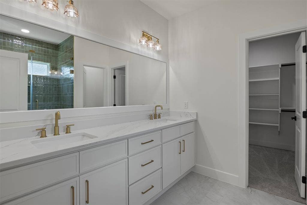2507 Picadilly Boulevard, Mesquite, TX 75149 Dual vanity with white cabinetry, gold-finish fixtures, and a white countertop