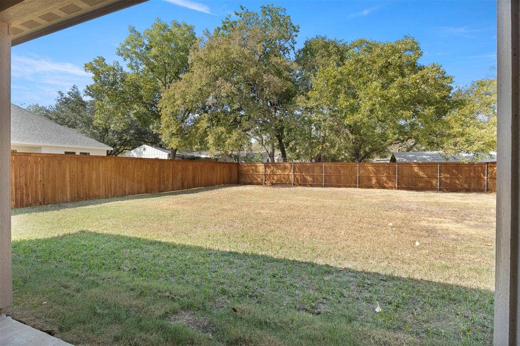 2507 Picadilly Boulevard, Mesquite, TX 75149 Expansive grass area with a surrounding wood fence and mature trees