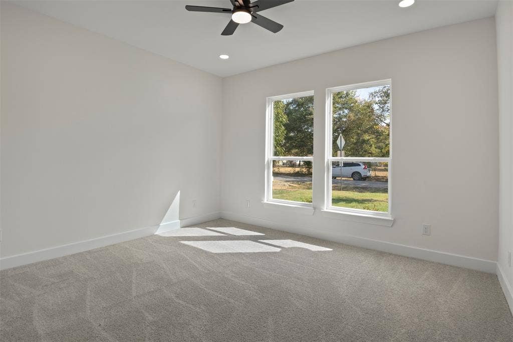 2507 Picadilly Boulevard, Mesquite, TX 75149 Light gray carpeting, two large windows, white walls, recessed lighting, and a ceiling fan with integrated lighting