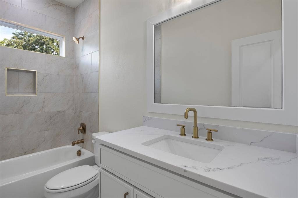 2507 Picadilly Boulevard, Mesquite, TX 75149 White vanity with a rectangular undermount sink, a stone-finish countertop, and gold-tone fixtures