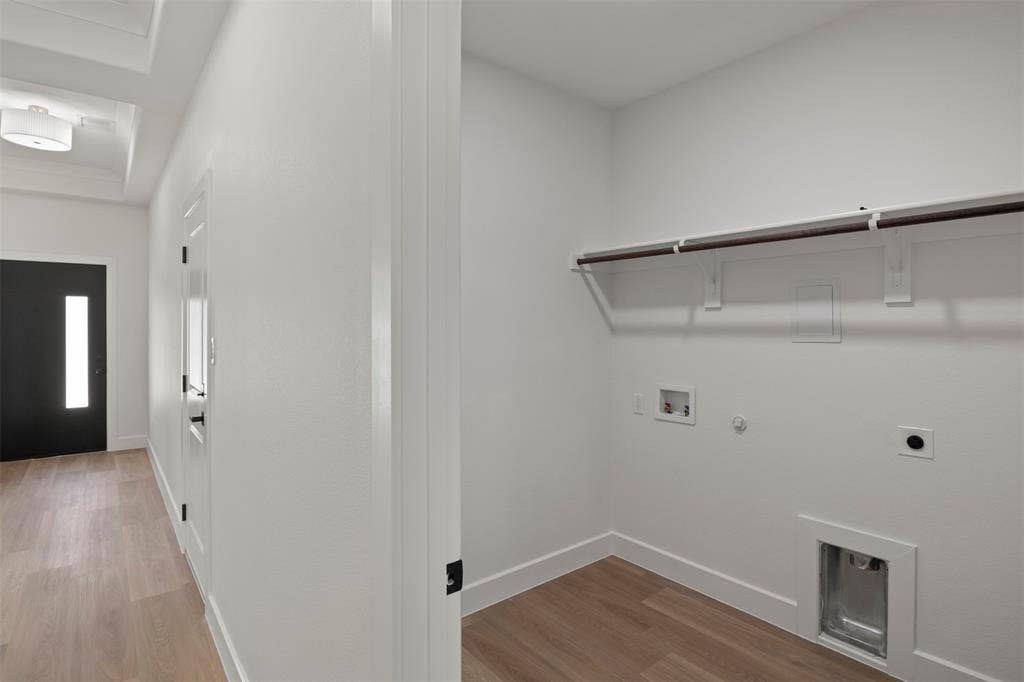 2507 Picadilly Boulevard, Mesquite, TX 75149 Utility space featuring wood-finish flooring, a clothing rod with shelving, and appliance hookups