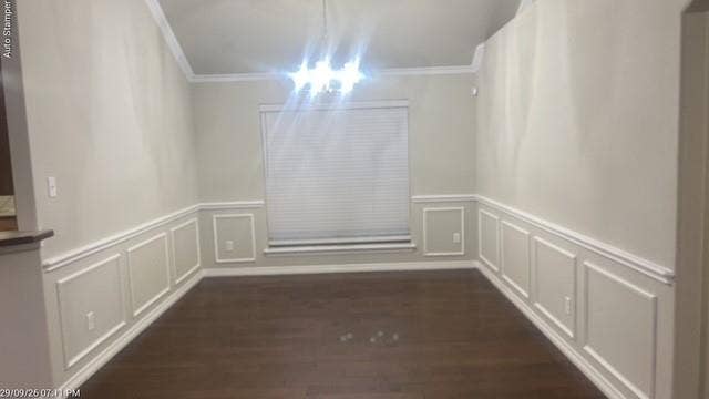Vaulted ceiling with crown molding, wood-finish flooring, accent wainscoting, and a window with blinds