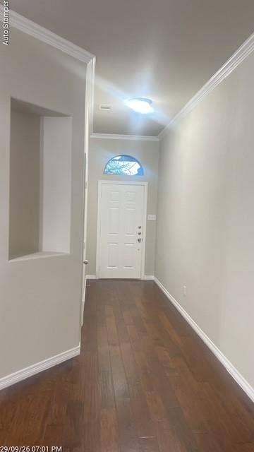 Entryway featuring wood-finish flooring, a white paneled door with an arched transom, and crown molding