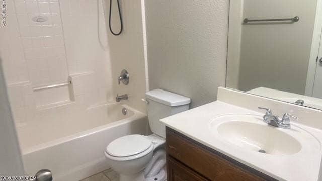 White bathtub with integrated shower, single-handle faucet, and built-in grab bar